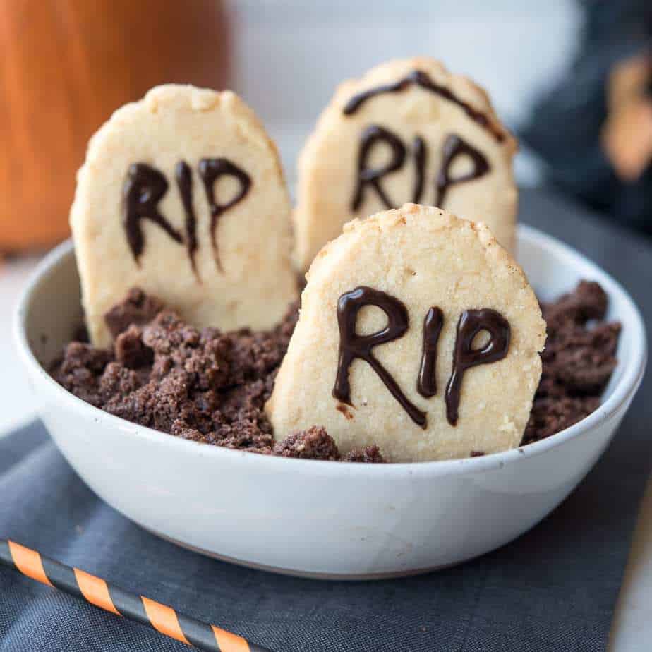 Paleo Halloween Tombstone Cookies in gluten-free "dirt" in a white bowl