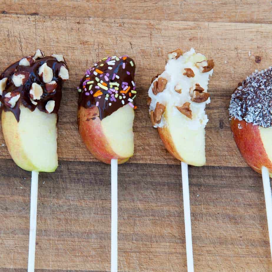 Paleo chocolate covered apples on a cutting board
