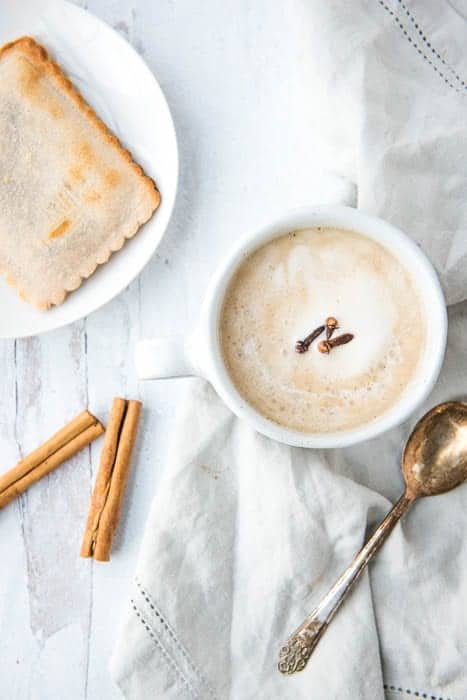 AIP Chai Latte in a white mug with a toaster pastry next to it