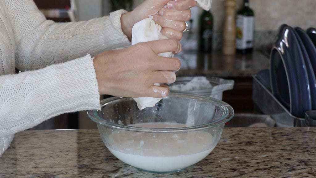 Squeezing the coconut milk out of a nut milk bag