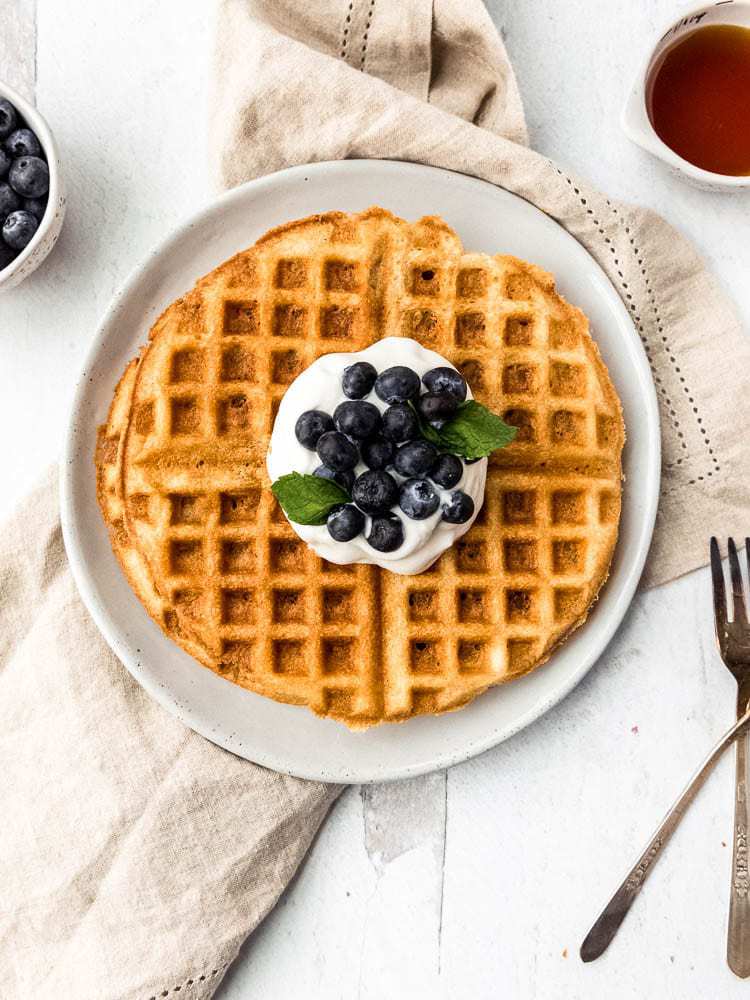 AIP waffles covered with coconut whipped cream, fresh blueberries and mint from above