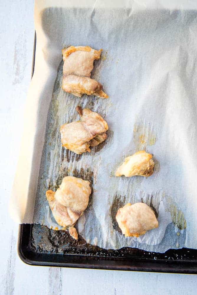 roasted chicken on a baking sheet covered in parchment paper