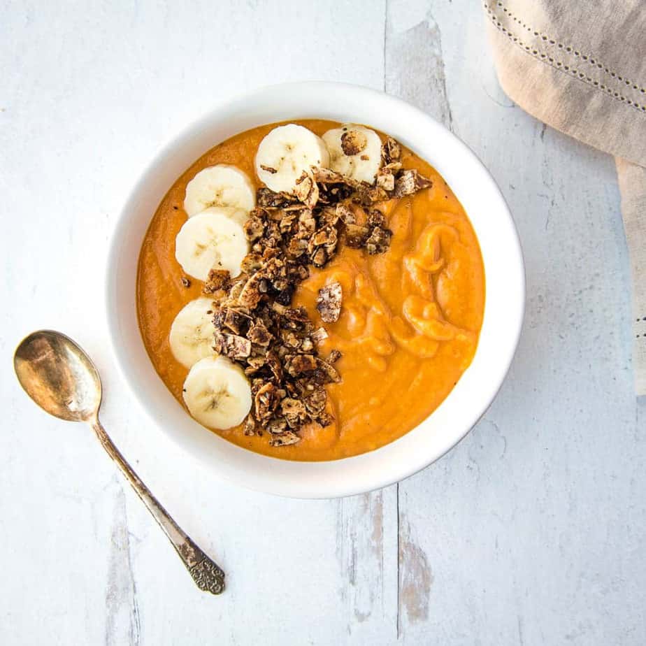 Sweet Potato Breakfast Bowl from above, covered with fresh banana slices and tigernut granola