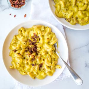 AIP mac and cheese on a plate from above, sprinkled with bacon bits
