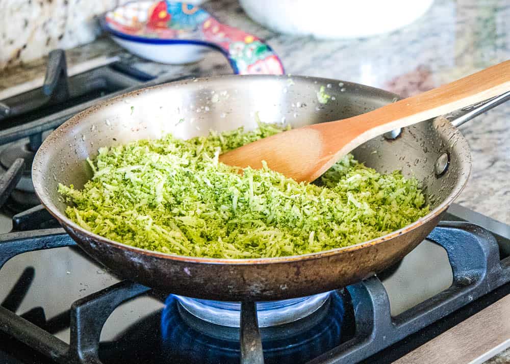 Broccoli Rice in a pan on the stove over a flame